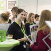 Eine junge Frau informiert sich an einem Stand der TU Dortmund