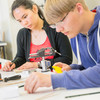 Two students handling components