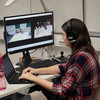 A woman at work with computer and laptop.