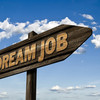 The picture shows an arrow-shaped sign with DreamJob written on it.