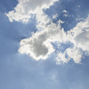 A blue sky with small white clouds.